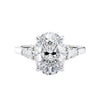 3 stone oval and pear diamond engagement ring white gold front view.