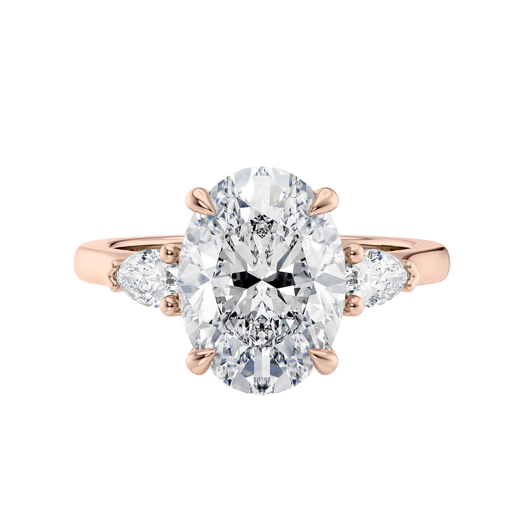 3 stone oval and pear diamond engagement ring rose gold front view.