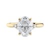 Lab grown oval diamond engagement ring with trilogy diamond set shoulders 18ct gold front view.
