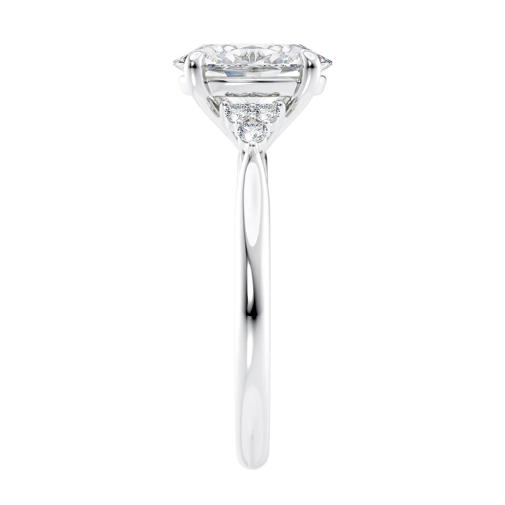 Lab grown oval diamond engagement ring with trilogy diamond set shoulders 18ct white gold end view.