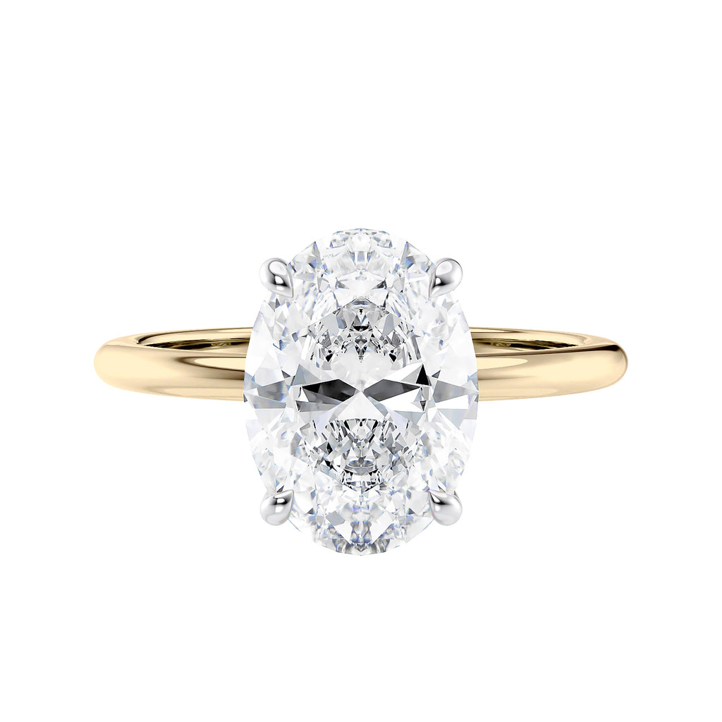Oval solitaire diamond engagement ring with a hidden halo in gold front view.