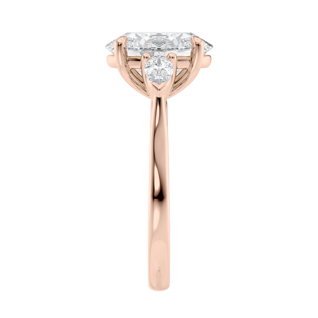 Oval Lab grown diamond three stone engagement ring with pear cut accent stones 18ct rose gold end view.