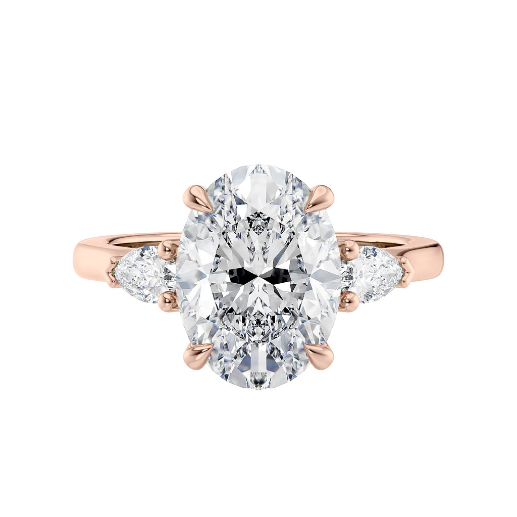 Oval Lab grown diamond three stone engagement ring with pear cut accent stones 18ct rose gold front view.