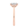 Natural oval hidden diamond bridge engagement ring with rose gold band end view.