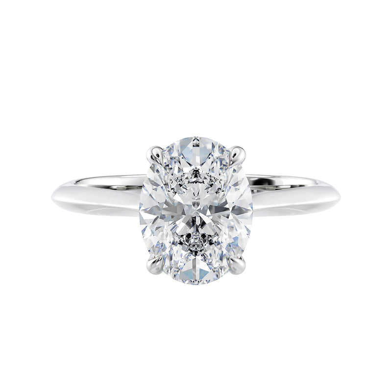 Natural oval hidden diamond bridge engagement ring with white gold band front view.