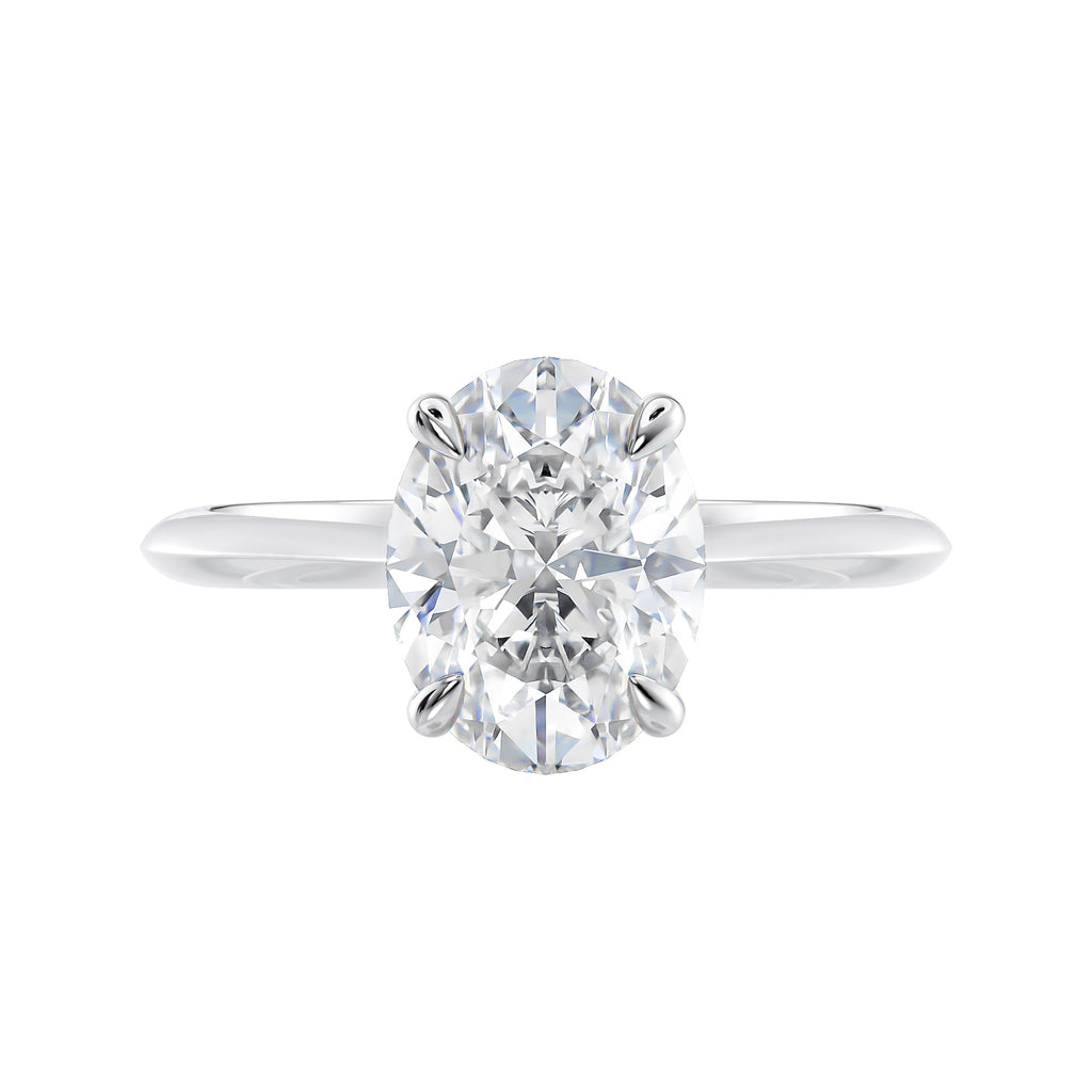 Oval solitaire diamond engagement ring with hidden halo and knife edge shank white gold front view.