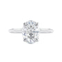 Oval solitaire diamond engagement ring with hidden halo and knife edge shank white gold front view.