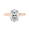 Oval solitaire with ultra slim rose gold band front view.