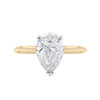 Natural pear cut diamond engagement ring with a hidden halo and 18 gold band front view.