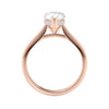 Natural pear cut diamond engagement ring with a hidden halo and 18ct rose gold band side view.