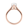 Natural pear cut diamond engagement ring with a hidden halo and 18ct rose gold band side view.