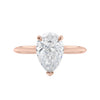 Natural pear cut diamond engagement ring with a hidden halo and 18ct rose gold band front view.