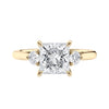 Lab grown square diamond 3 stone engagement ring in gold setting front view.
