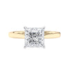 Princess cut solitaire diamond engagement ring with gold band front view.