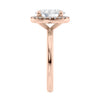 Oval halo diamond engagement ring in rose gold end view.