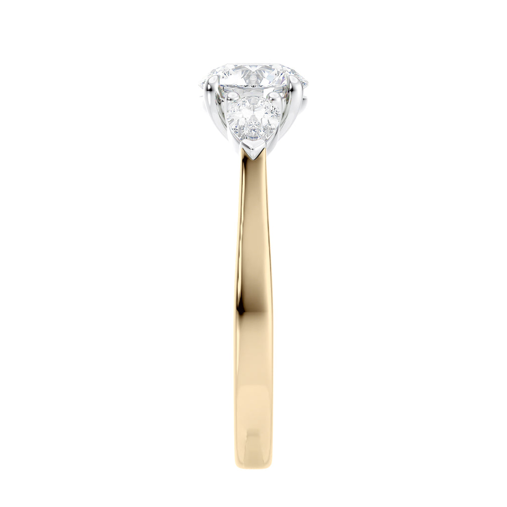Round and pear three stone natural diamond engagement ring in 18ct yellow gold end view.