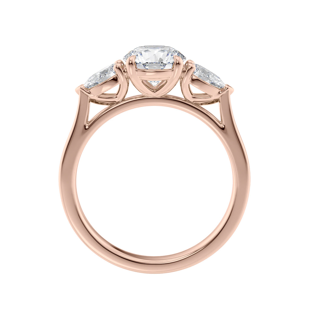 Rose gold round and pear three stone natural diamond engagement ring side view.