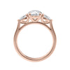Rose gold round and pear three stone natural diamond engagement ring side view.